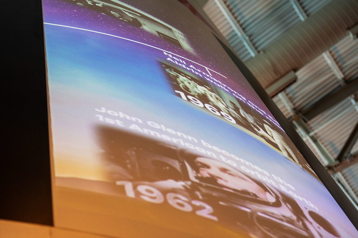 A rocket projection displaying a timeline of flight history, enabling visitors to absorb digital educational content effortlessly.